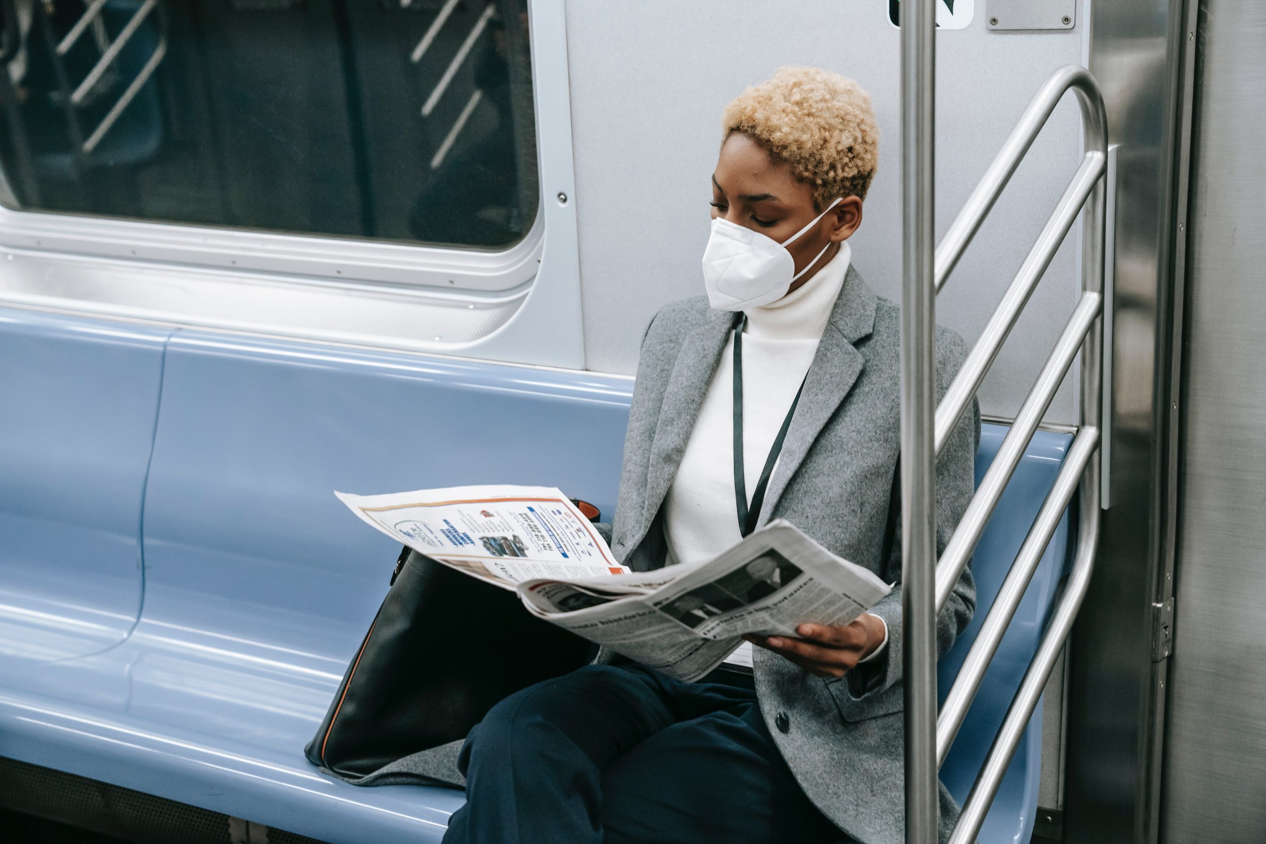 Woman in subway wearing a mask.
